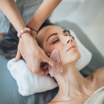 Woman resting during gentle facial gua sha massage at Seneca Falls Acupuncture.