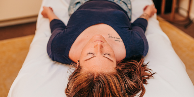 A patient resting on the table while she waits for her cosmetic acupuncture treatment to begin at Seneca Falls Acupuncture.